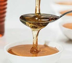honey poured over a spoon