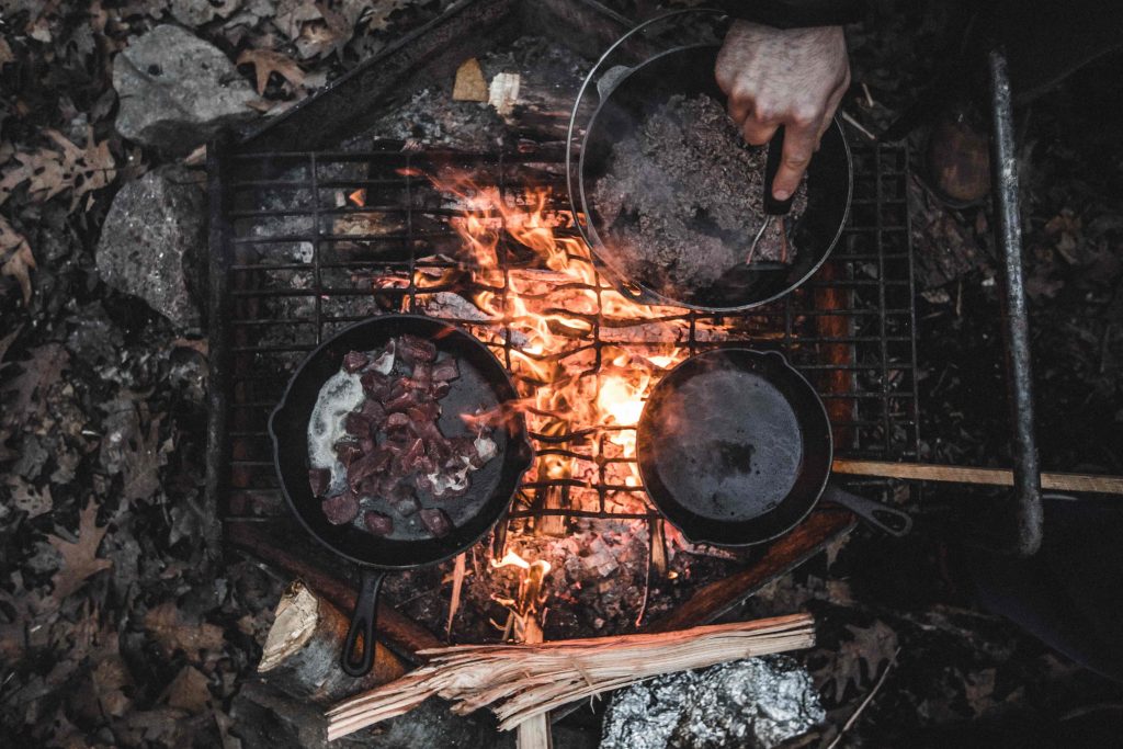 Hikers cooking over an open campfire