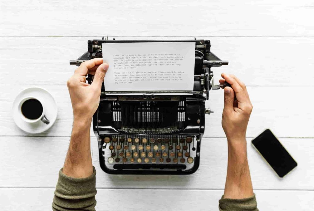 writer typing on a typewriter