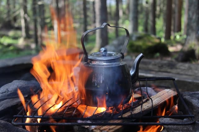 cooking over a campfire using firewood