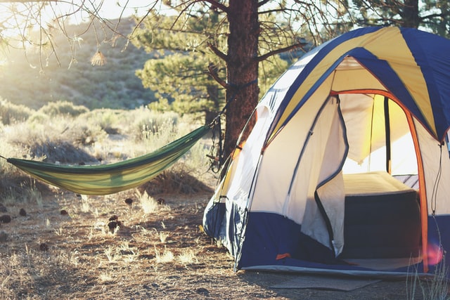 camping hammock and tent at sunrise