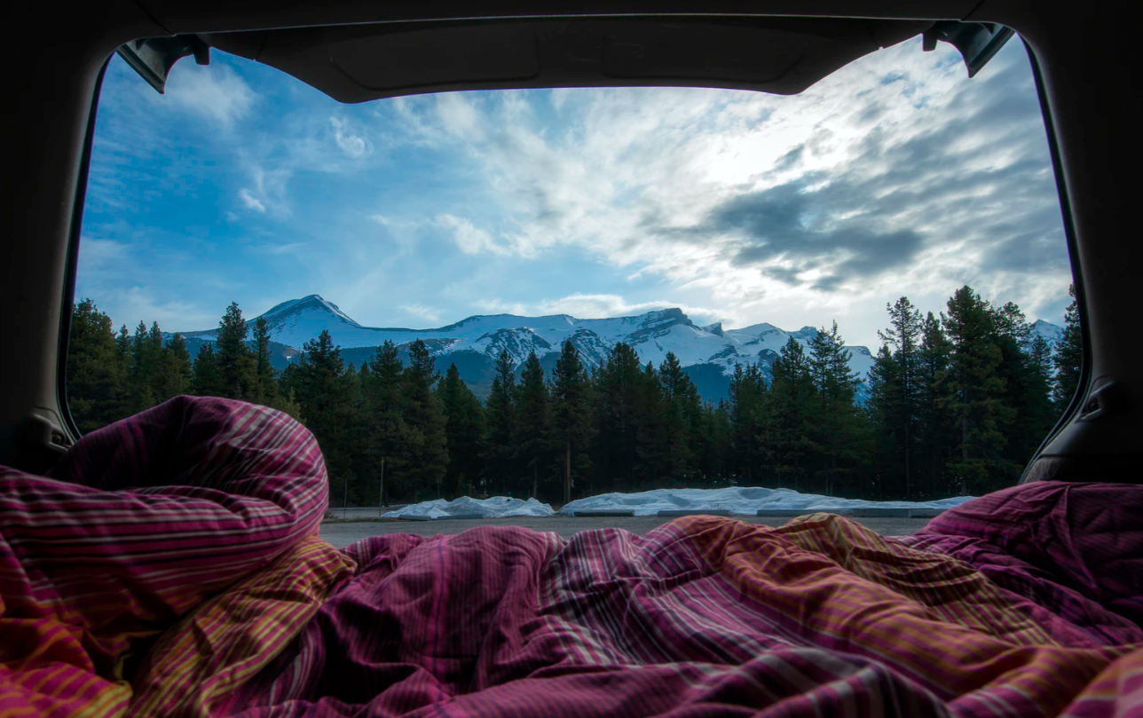 camping blanket in a tent overseeing the outdoors in the mountains