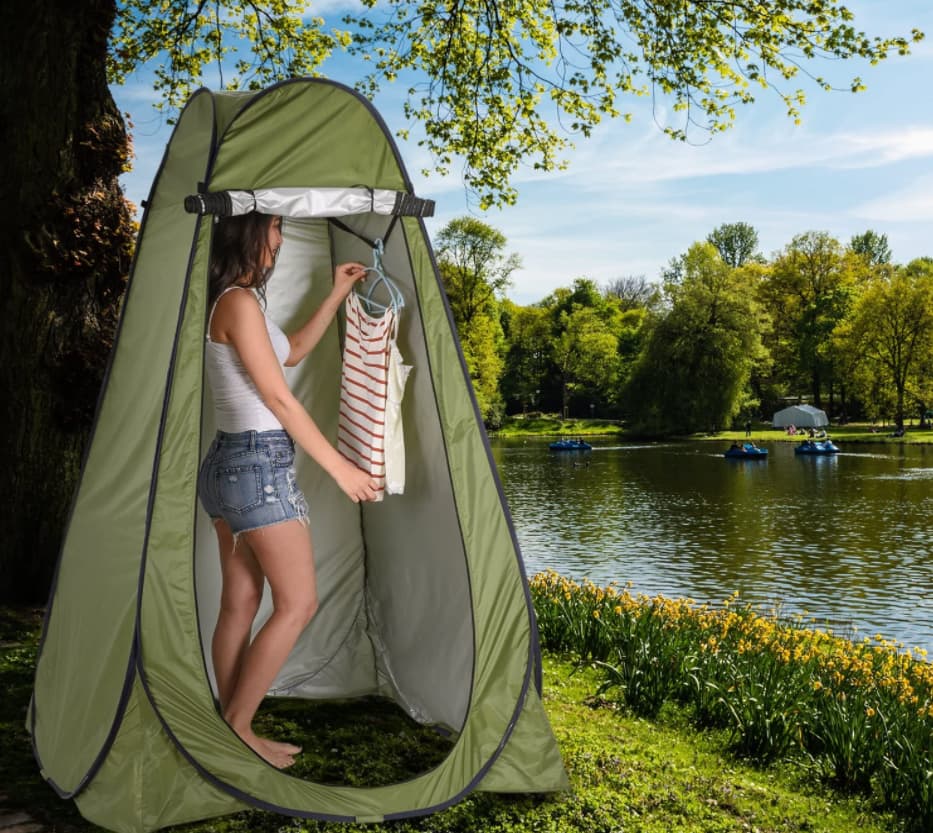 woman in a portable shower for camping