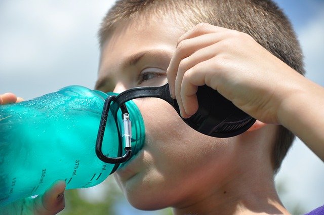 boy drinking fresh water from a water bottle