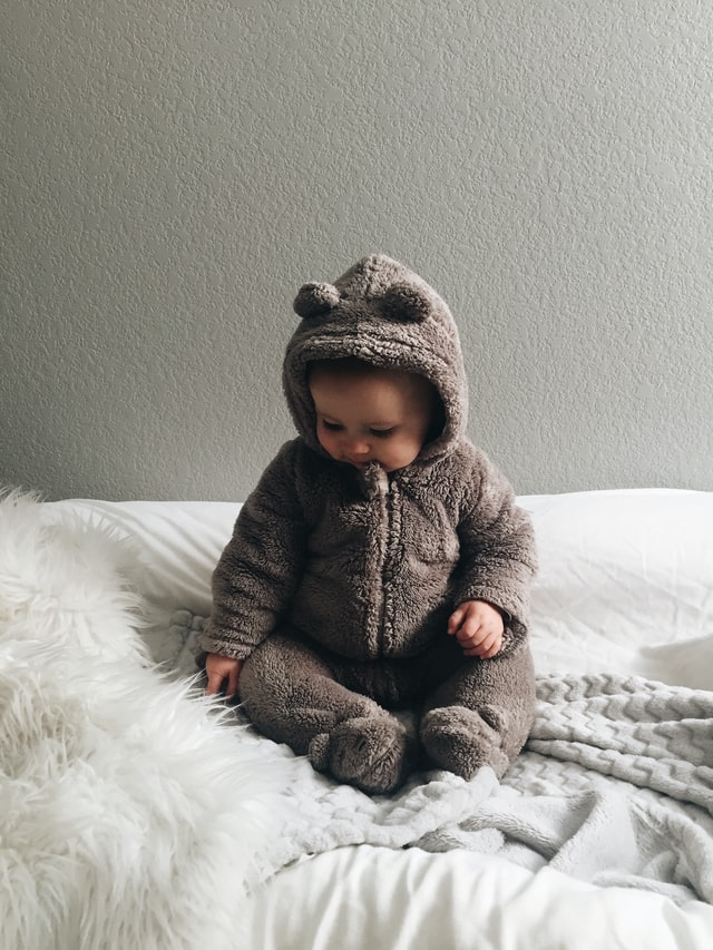 baby in a warm fuzzy bear jacket