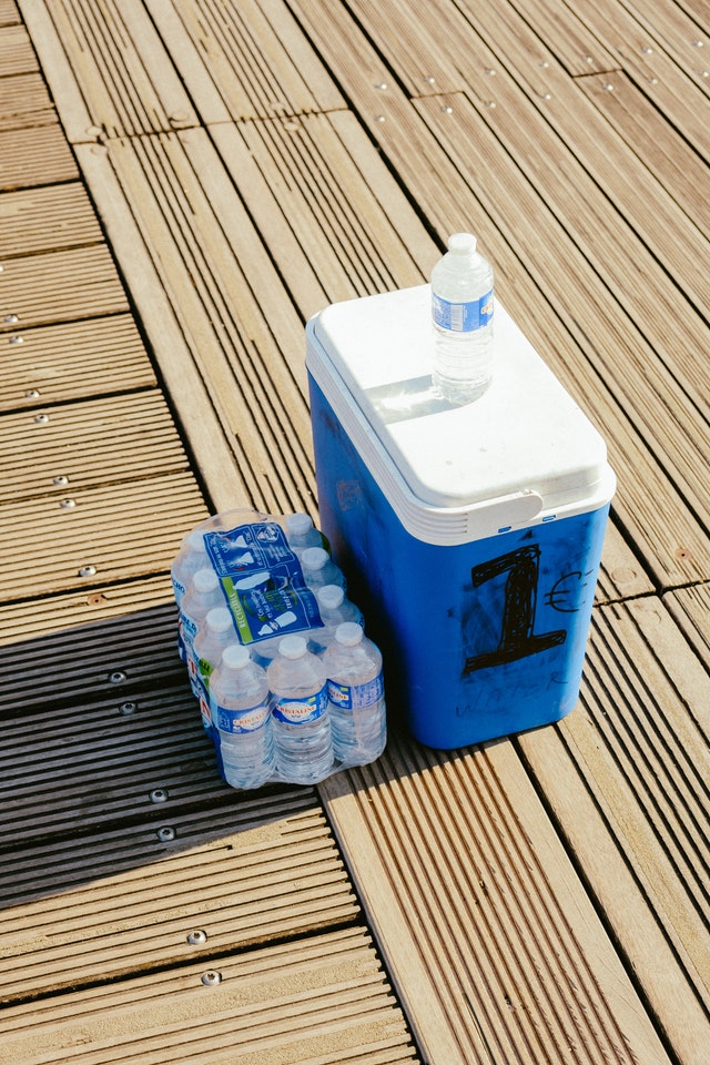 a blue cooler packed with bottled water