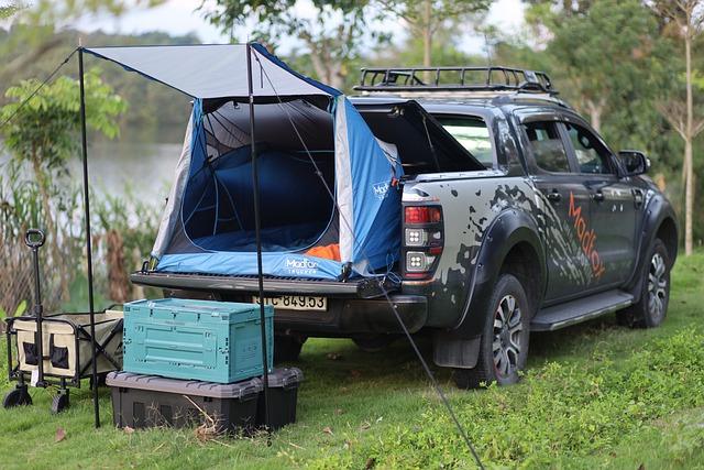 camping cooler behind a truck with a tent
