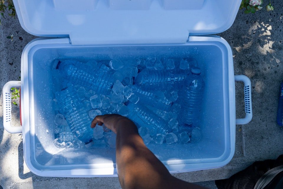 water bottles and ice filled large camping cooler