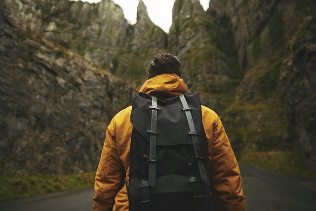 backpacker with an ultralight tent packed in his backpack